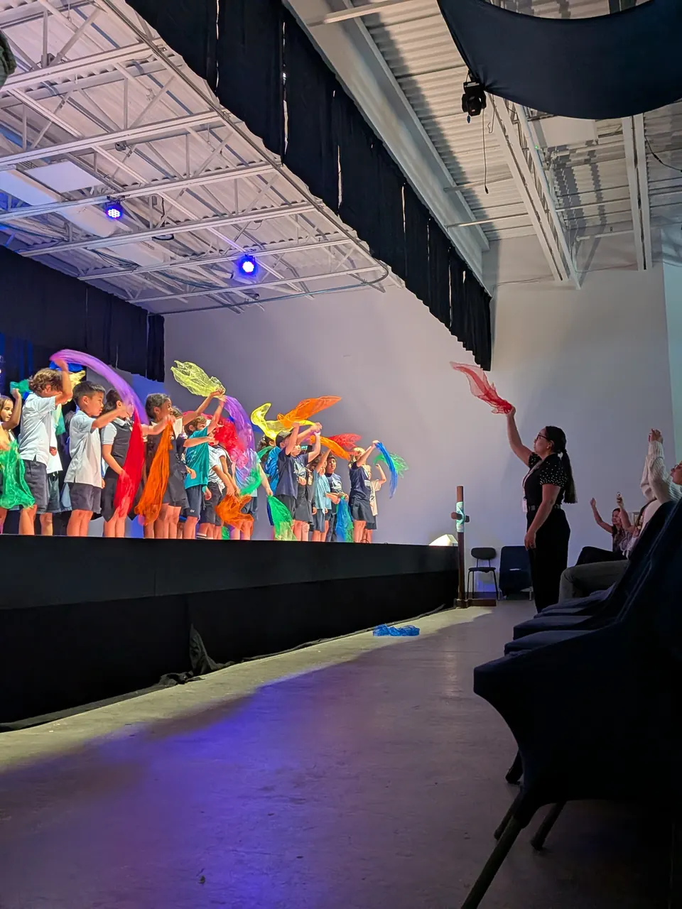 Students dancing with colourful ribbons at the arts showcase
