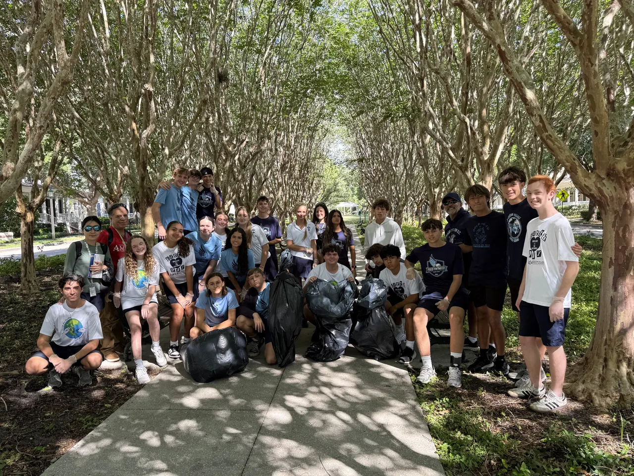 Students after a community cleanup with their collected bags