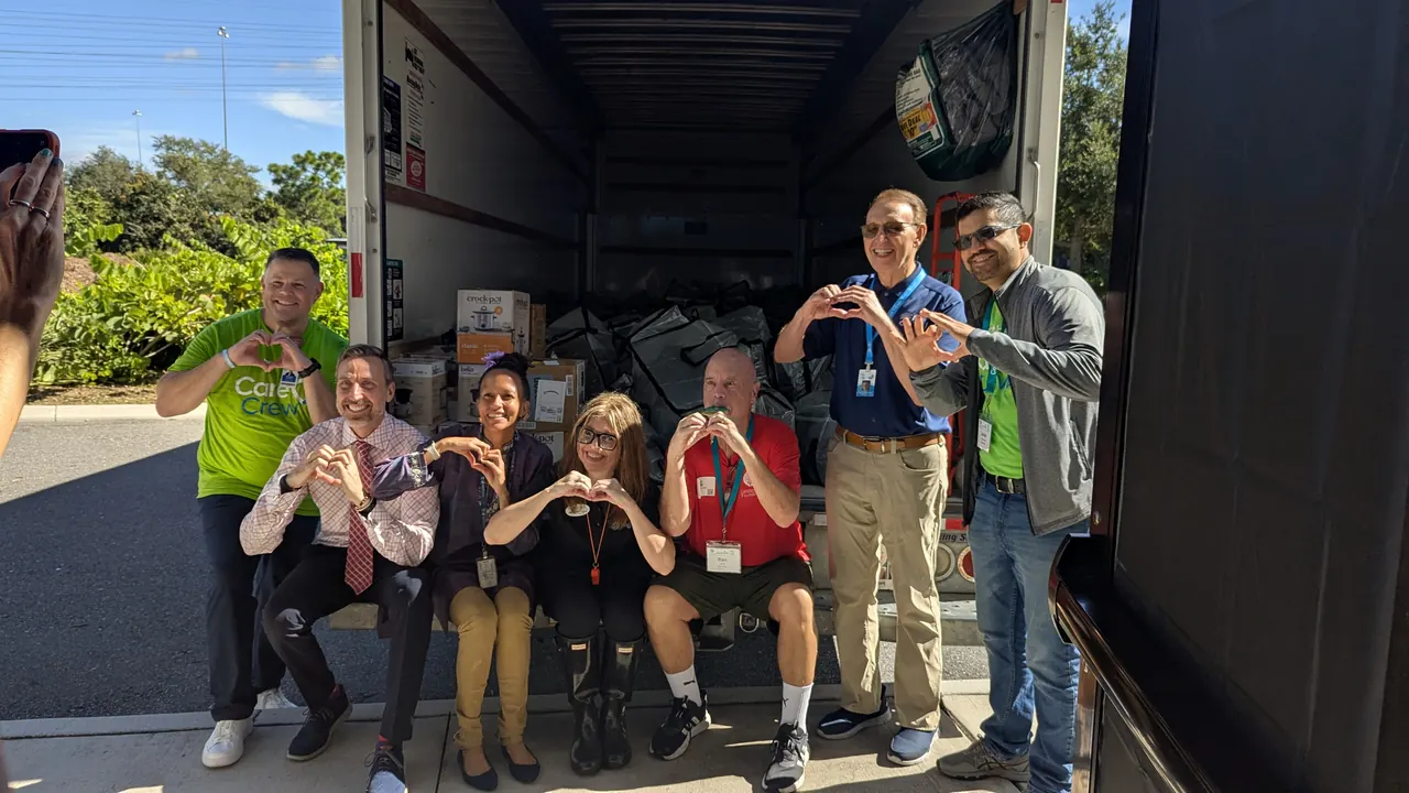 Students and staff loading donations for a community drive