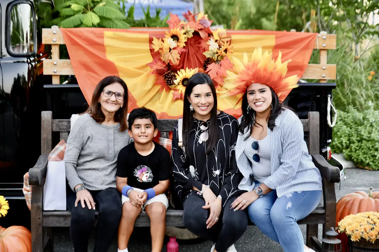 A family at the Fall Harvest Festival photo booth