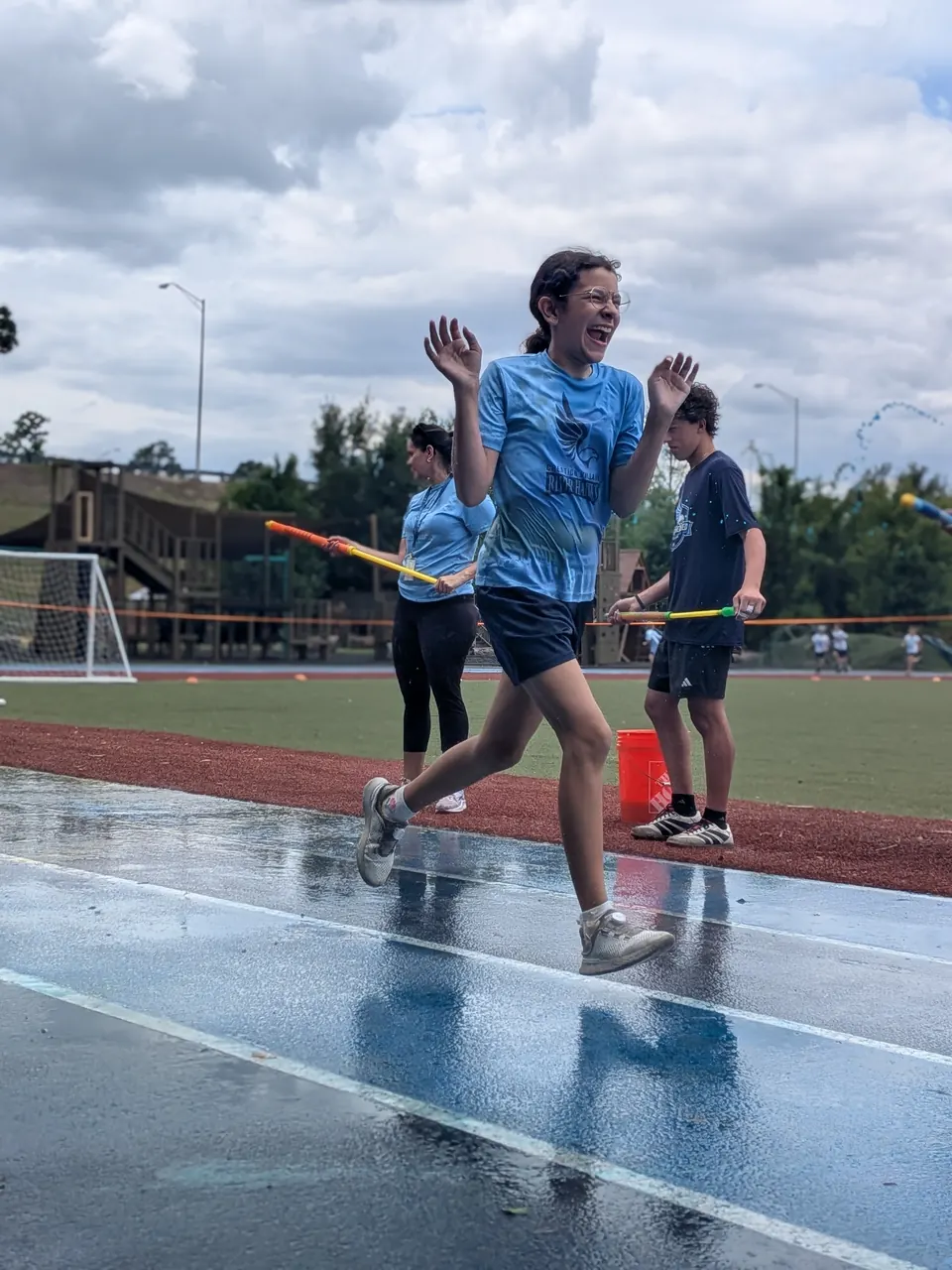 Students racing on the track at field day