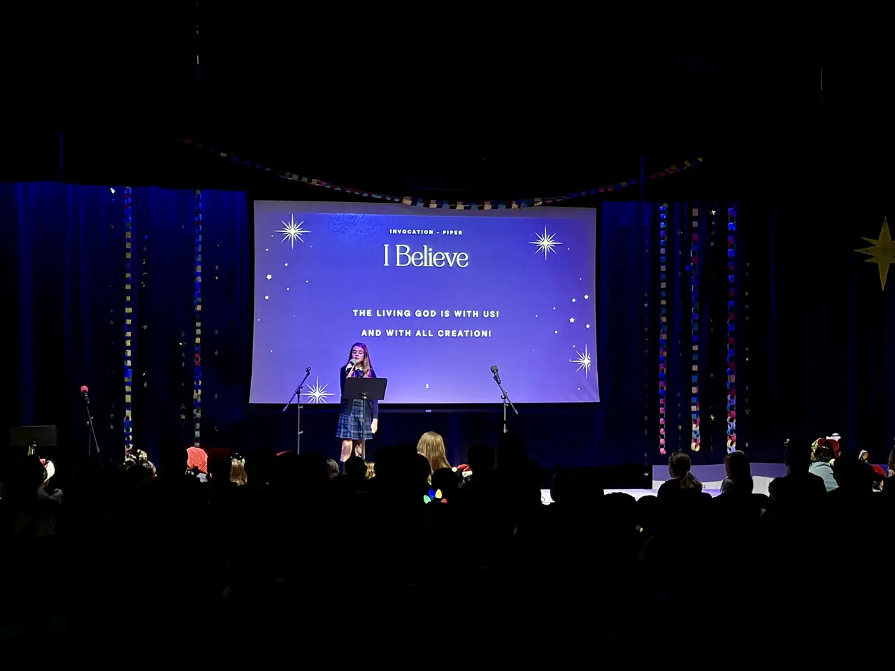 Students leading worship on stage