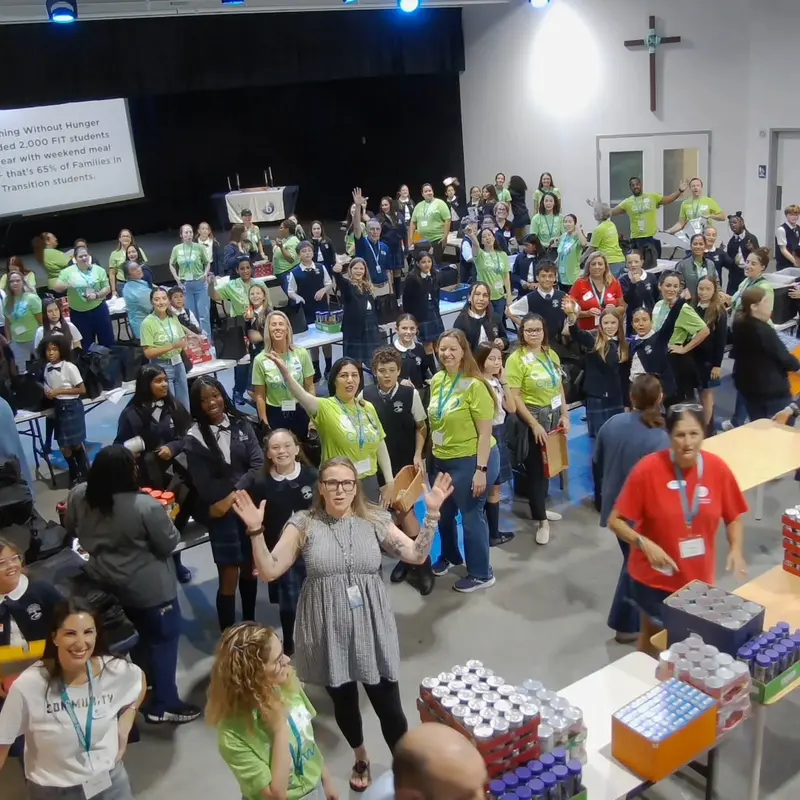 Students and volunteers packing meals for local families