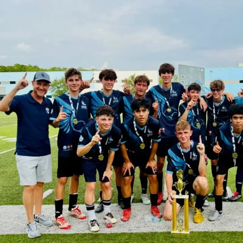 The River Hawks boys soccer team celebrating the CFCAA championship